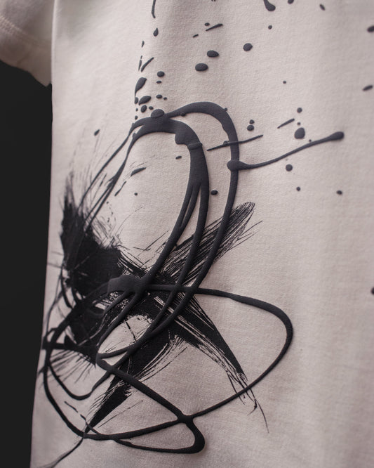 Close-up of raised ink and abstract brush print texture on the DVYNDRIP Creator T-shirt