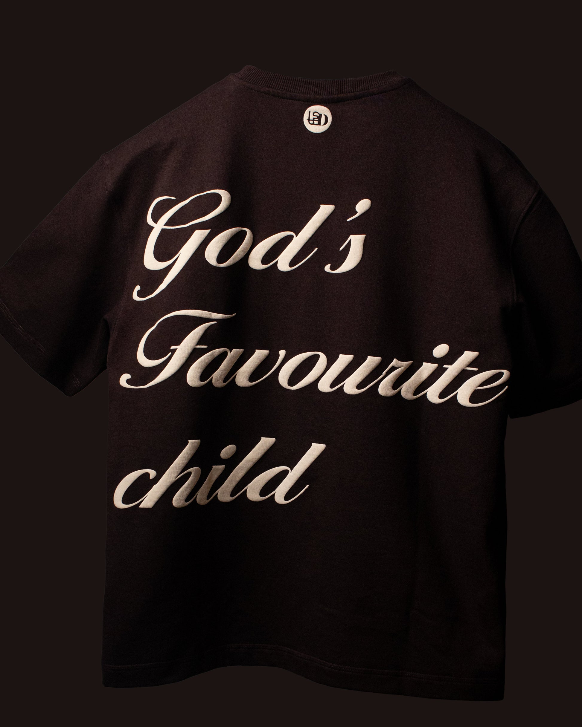 Full back view of the DVYNDRIP God’s Favourite Child T-shirt showcasing the statement script design