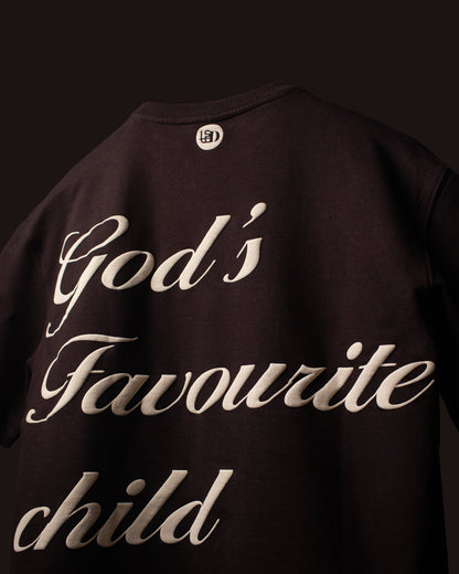 Back view of the DVYNDRIP God’s Favourite Child T-shirt featuring cream script typography on dark brown fabric
