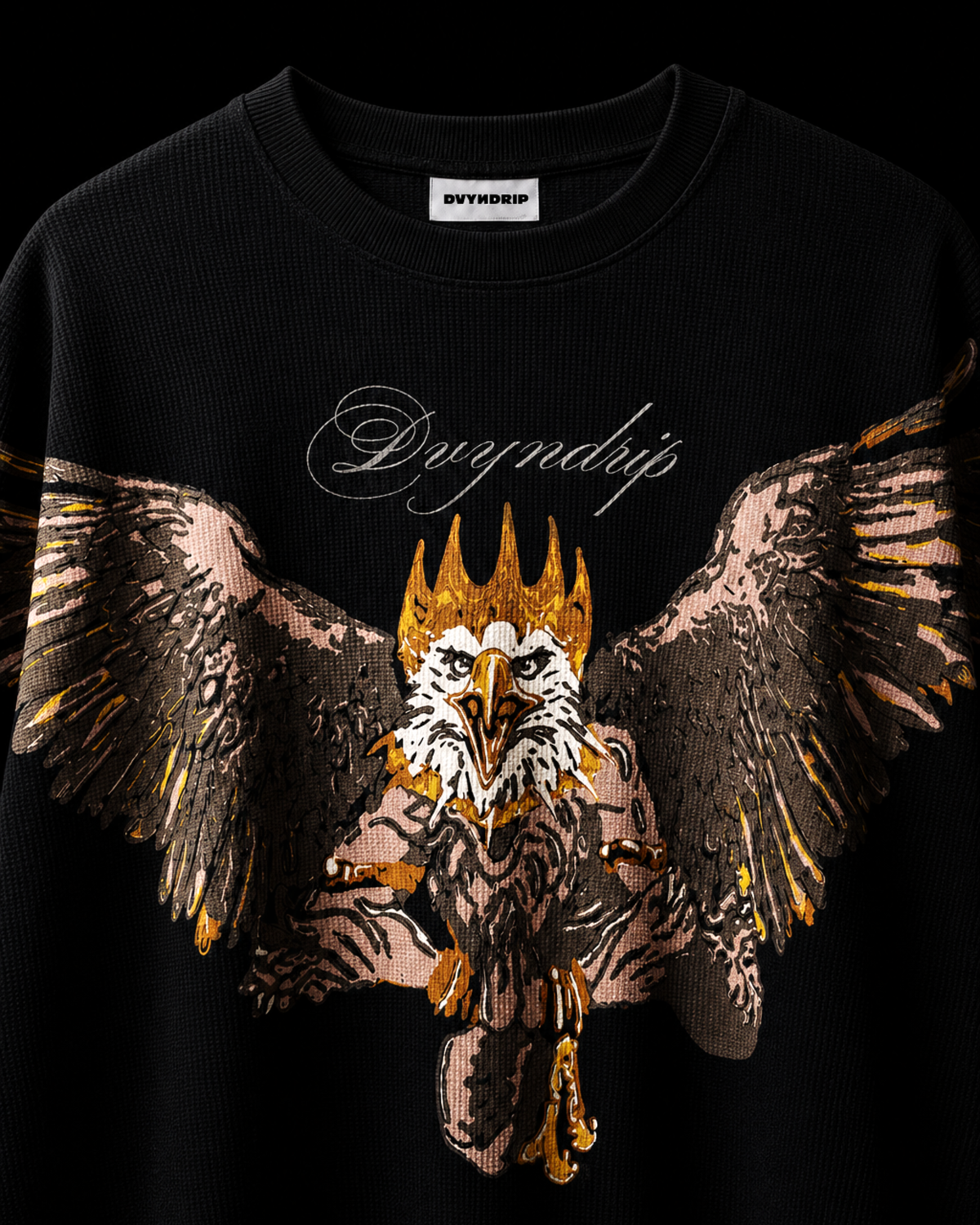 A black full-sleeve waffle t-shirt featuring a large graphic print of a crowned eagle (GARUD) with outstretched wings in gold, brown, and white, with the word 'DVYNDRIP' in white script above it.